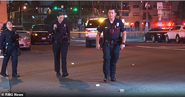 LAPD officers found three men and one woman on the lobby floor with gunshot wounds