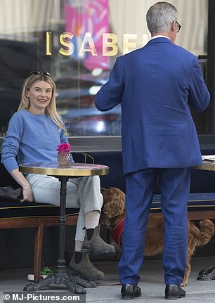 Happy days: Toff smiled while sitting with her pooch and chatting with Farage