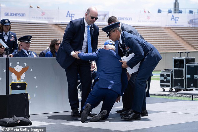 President Joe Biden is helped to his feet after falling during graduation at the United States Air Force Academy in Colorado on Thursday.  He fell while presenting diplomas to the cadets