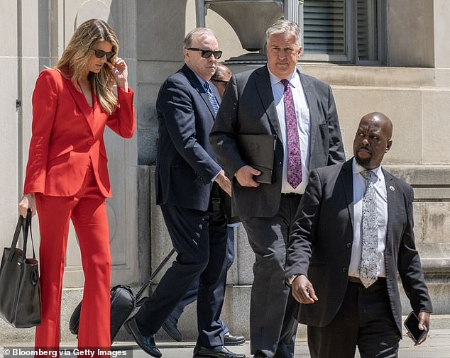 Trump attorneys Lindsey Halligan (from left), John Rowley and James Trusty exit the Justice Department Monday after a meeting with federal prosecutors