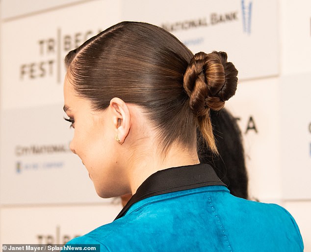 Sleek: The actress had her long brunette tresses pulled away from her face in a slick bun