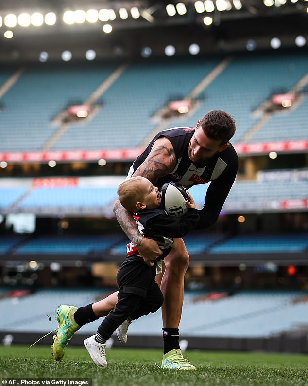 As they ran across the grounds, father and son performed a gentle tackle