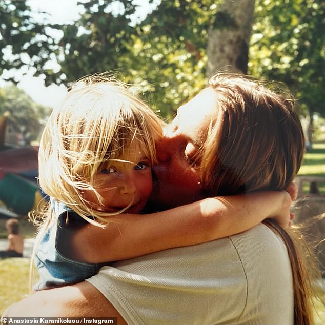 Fond memories: The second photo was taken with her mum holding Stassie in her arms and giving her a loving kiss on the cheek