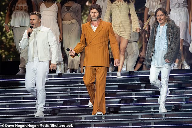 Fashion savvy: He wore matching wide-bottomed trousers and opted for a comfy pair of white trainers