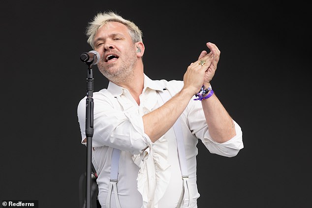 Feeling radiant: The pop star wore a pair of chic white trousers to match his shirt, complete with some suspenders in the same colour