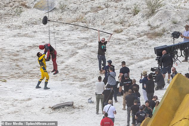 Huge production: Hugh, 54, was back in his yellow Wolverine suit when he was seen wrestling Ryan, 46, who was once dangling from a tightrope