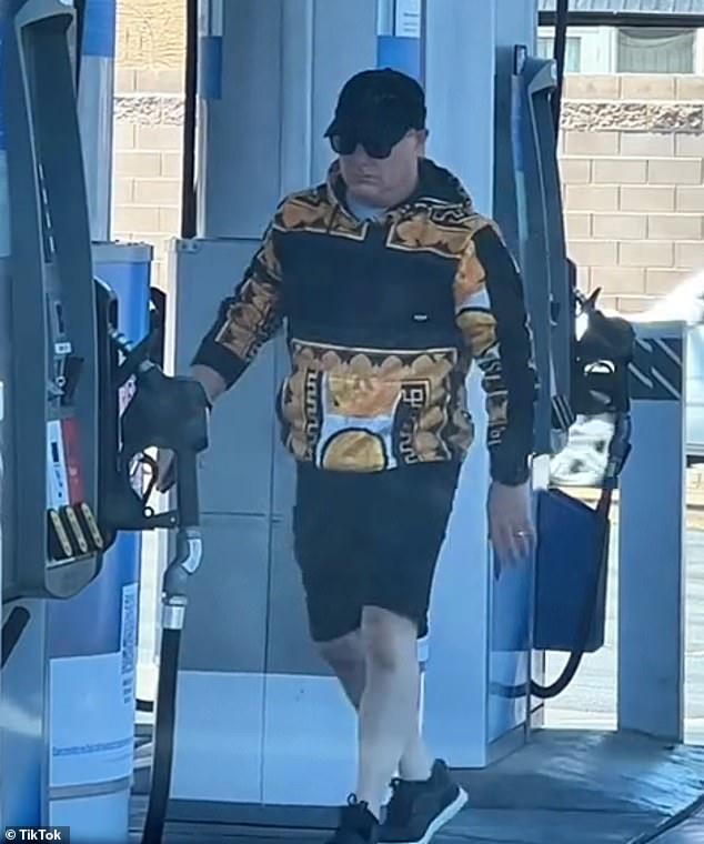 Suddenly, a man in shorts, a yellow and black hoodie, sunglasses and a baseball cap got out of the car and walked into the store