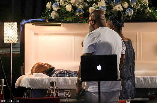 Sibley's parents stand over their son's coffin as he bids his last farewell during viewings at The Met Philadelphia in Philadelphia, Pennsylvania on Tuesday