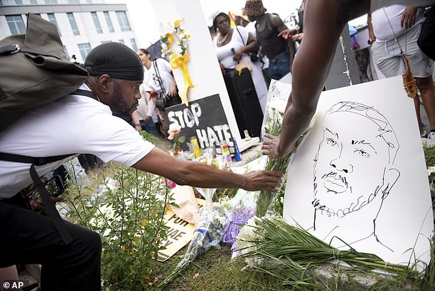 A friend of Sibley's lays a bouquet of flowers during the vigil to commemorate the young dancer