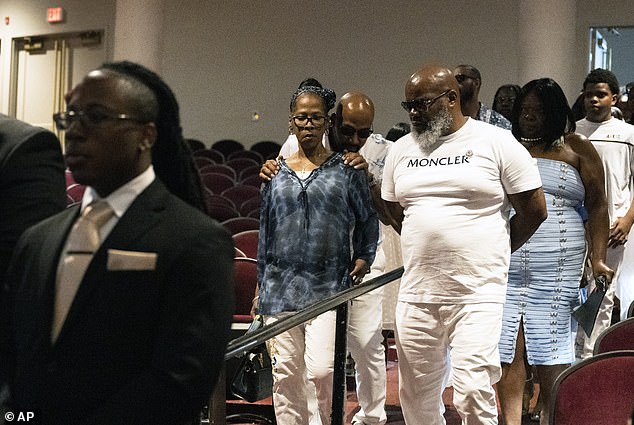 Sibley's somber parents, Jake Kelly and mother Onetha Sibley, walk down the aisle while celebrating the life of their son O'Shea Sibley at The Met in Philadelphia on Tuesday