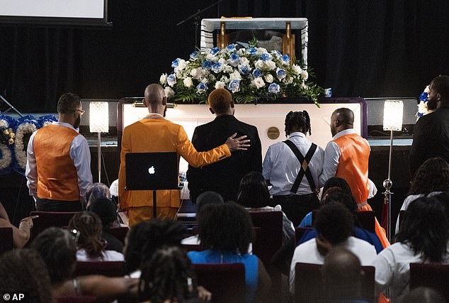 Friends of Sibley gather near his coffin to say their final goodbyes