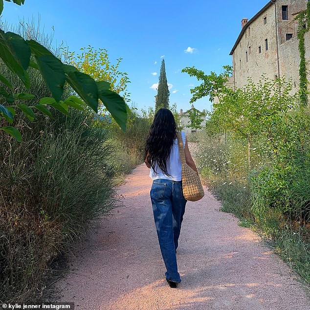 She was strolling around in comfortable blue jeans and a flowy white blouse