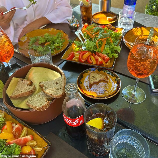 Aperol Spritz: A glass bottle of Coca Cola and two glasses of Aperol Spritzes were among the drinks featured on the table full of food included in Jenner's Instagram post