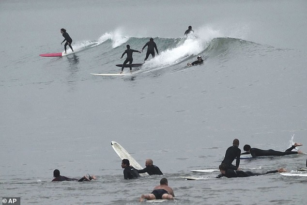 While the majority of people took shelter from the storm, others braved the wet conditions to sunbathe in the precursor to the storm, which had expanded to the size of the state of Arizona