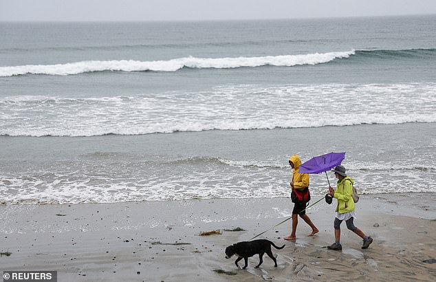 A few stragglers were seen in raincoats with umbrellas as the angry sea lashed at a pier in Imperial Beach, while some in San Diego strolled along the shore while they still could