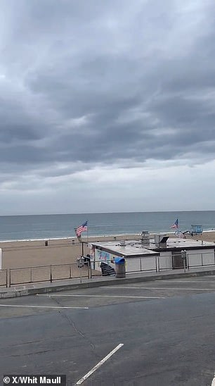 Residents watched as the sky turned from the deep colors of the sunset to a dull gray and gathering clouds