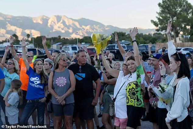 Mourners are seen joining Probst's family at the scene where he was killed in northwest Las Vegas