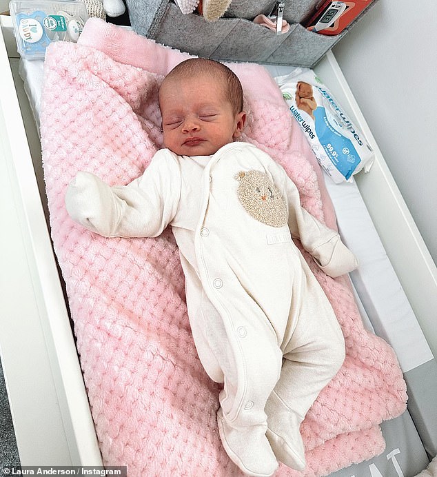 Cutie: In another snap, little Bonnie looked adorable in a cream baby onesie as she dozed on her changing table