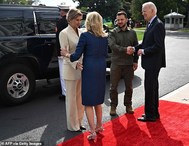 Jill Biden hugs Olena Zelenska as President Joe Biden greets President Volodymyr Zelensky upon their arrival at the White House