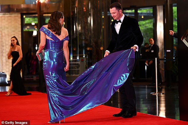 Patrick opted for a velvet tuxedo jacket, while Mardi walked to the beat of her own drum in a metallic blue off-the-shoulder dress with a high slit and sparkling diamond accessories