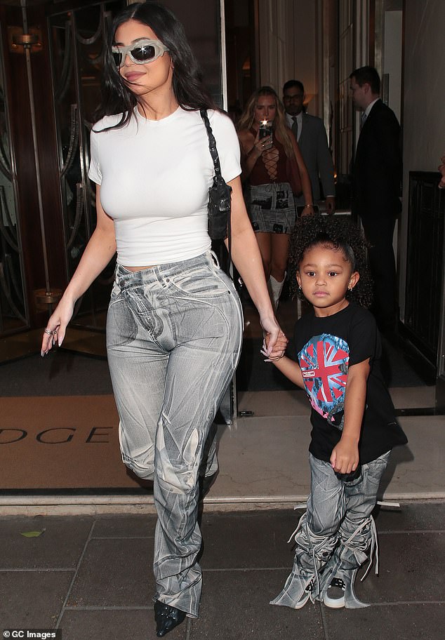 Hand in hand: Travis and Kylie are also the proud parents of a five-year-old daughter named Stormi, who Kylie was pictured with in London last year