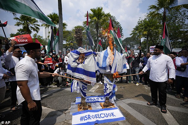 MALAYSIA: Muslims burn Israeli flags during a rally in support of Hamas in Kuala Lumpur on Friday