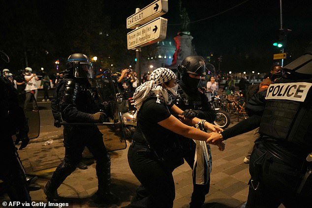 French riot police use tear gas to disperse protesters during a rally on October 12