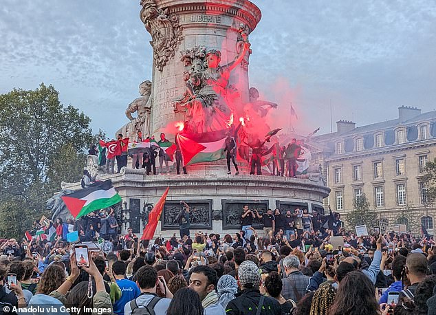 People take part in a pro-Palestinian rally at Place République in Paris, France on October 12