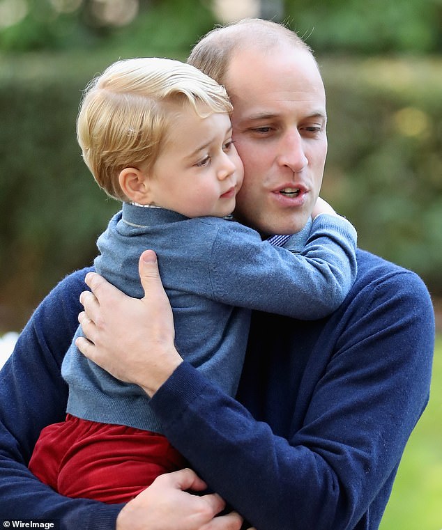 Prince William hugs Prince George during a children's party for military families during the Royal Tour of Canada in September 2016 in Victoria, Canada