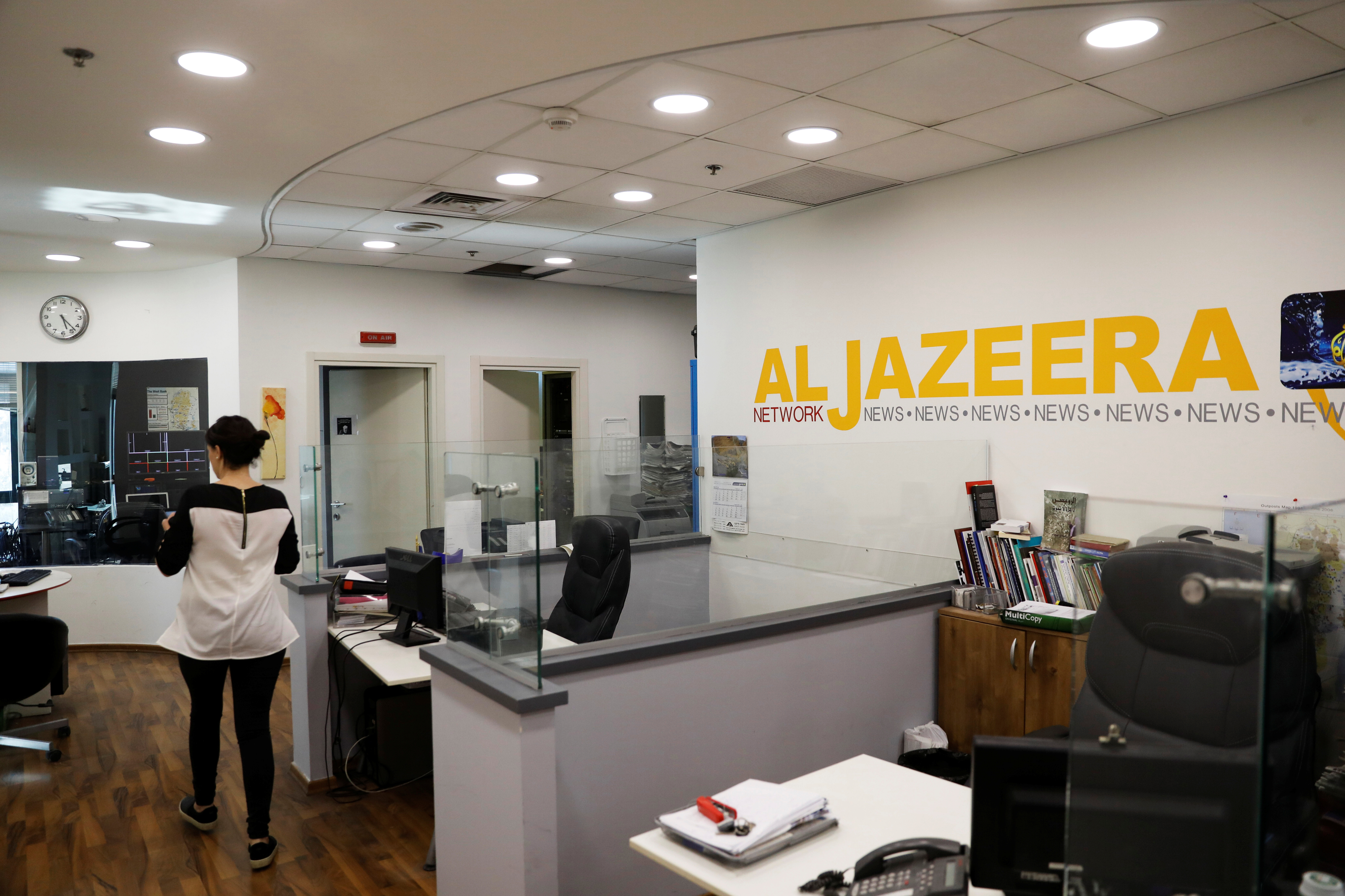 An employee enters an office of the Qatar-based Al Jazeera network in Jerusalem