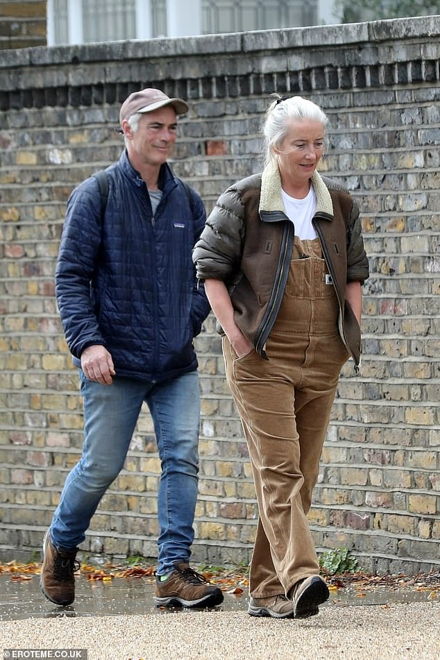 Smile: The loved-up couple - who have been married for two decades - were in hiking gear as they walked through Hampstead