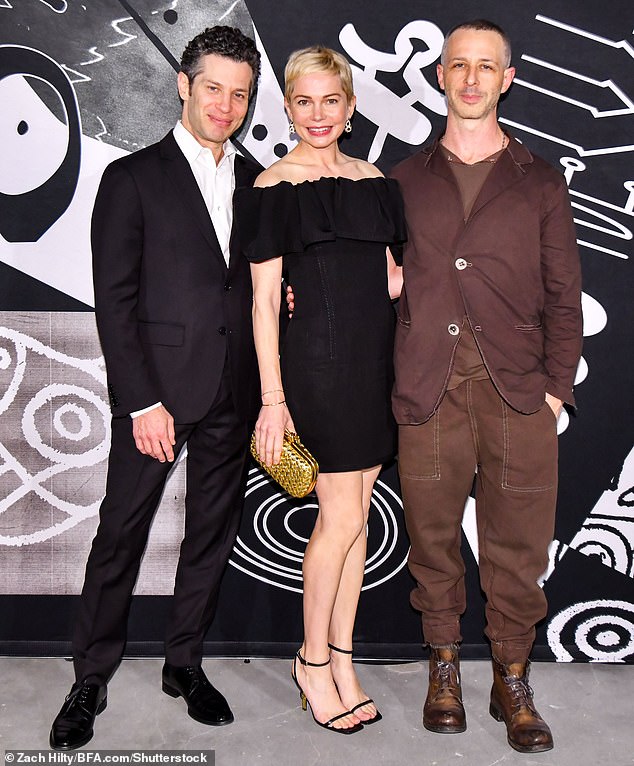 Fashion: The 43-year-old actress cut a chic figure in a black mini dress as she posed with her 45-year-old theater director Beau (left) and actor Jeremy Strong (right) at the event.