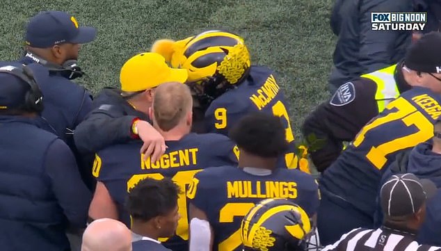 Michigan quarterback JJ McCarthy was pictured on the sideline hugging Zinter's parents