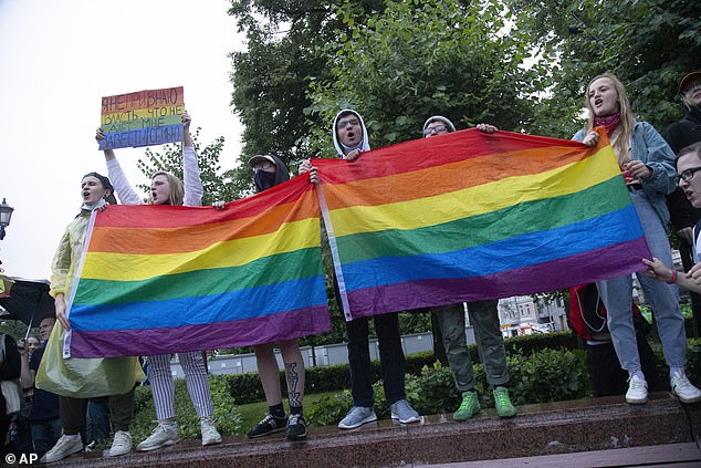 LGBT activists wave their flags during a rally to annul the results of voting on constitutional amendments in Moscow, Russia, July 15, 2023