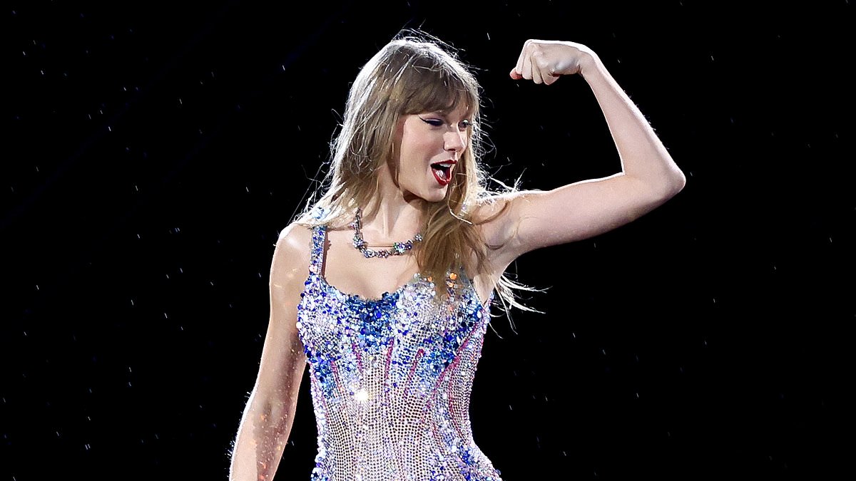 Taylor Swift shines in a stunning silver bodysuit and boots