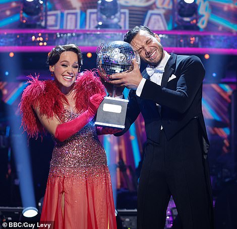 The couple couldn't wipe the smiles off their faces as they posed with the shiny trophy