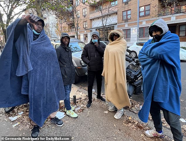 Ibrahim from Chad (far left) has been waiting for new temporary accommodation for five days and claims officials kept telling him to come back the next day