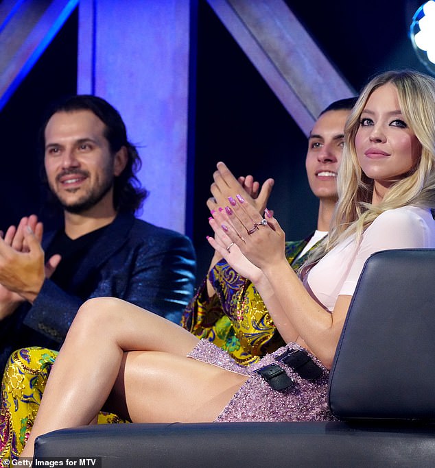 According to reports, Jonathan is part of a family that owns the device technology and packaging company Final Bell and 14th Round.  He is also Sydney's production partner (pictured left 2022: Jonathon, pictured right: Sydney)