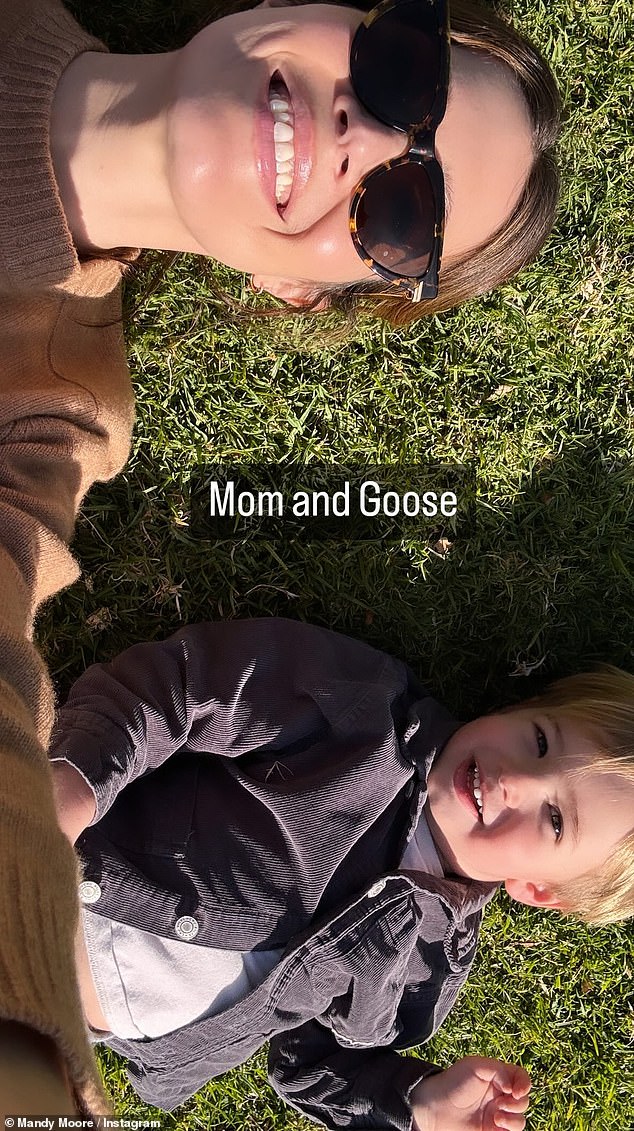Moore then shared a selfie of herself lying next to her two-year-old eldest son August as they spent time together on a patch of grass