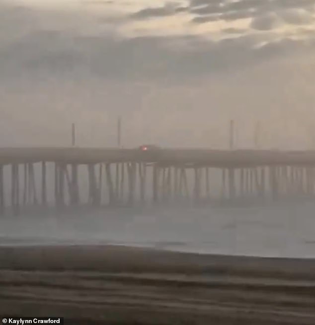 The car's taillights were visible as it drove down the pier