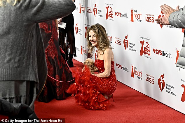 Here she was seen playing with a small dog on the red carpet