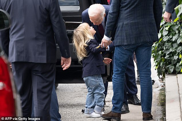 President Biden leans down to give grandson Beau a kiss