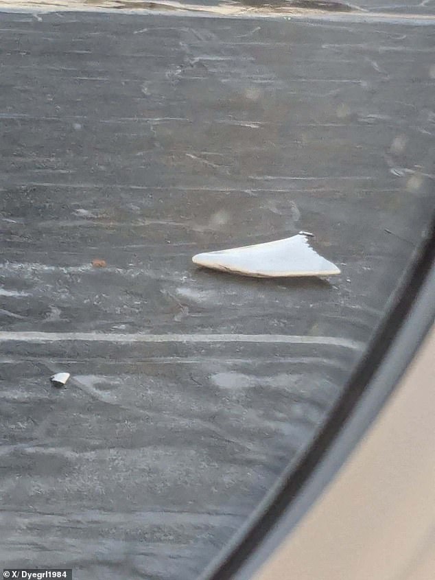 Debris from a plane can be seen on the runway at Boston Airport