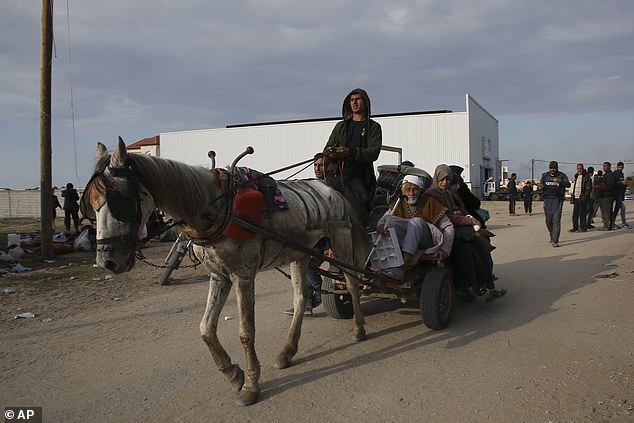 Palestinians fleeing the Israeli offensive against Khan Younis arrive in Rafah in the Gaza Strip