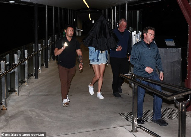 Police confirmed that 71-year-old Scott Swift allegedly attacked a photographer.  Taylor is pictured under the umbrella next to her father Scott (right)