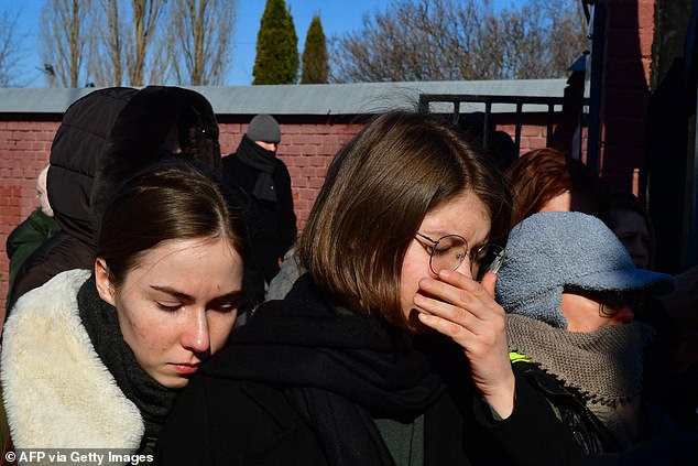 Mourners following the hearse in Moscow threw red carnations as it passed and were heard shouting: 