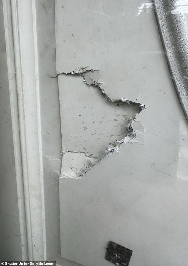 A broken door was visible at the Amityville property searched by police on Monday